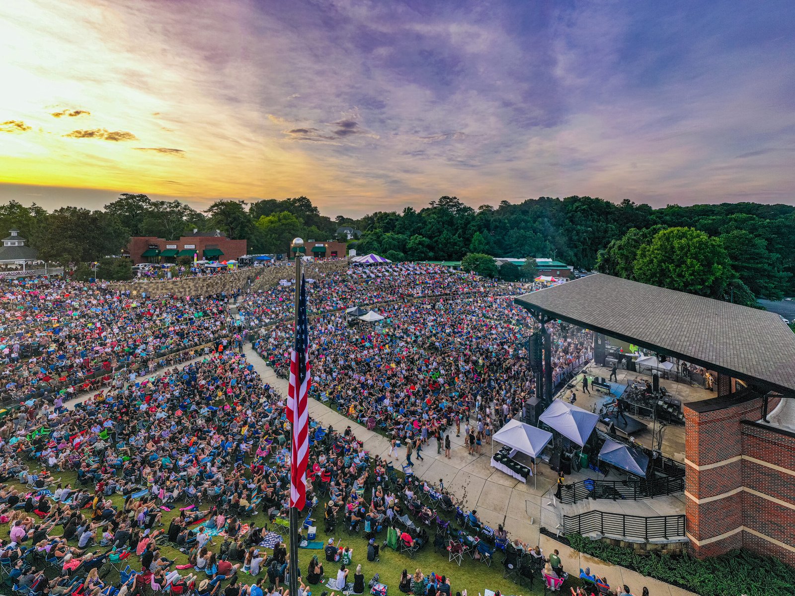 A packed community amphitheater at a county event